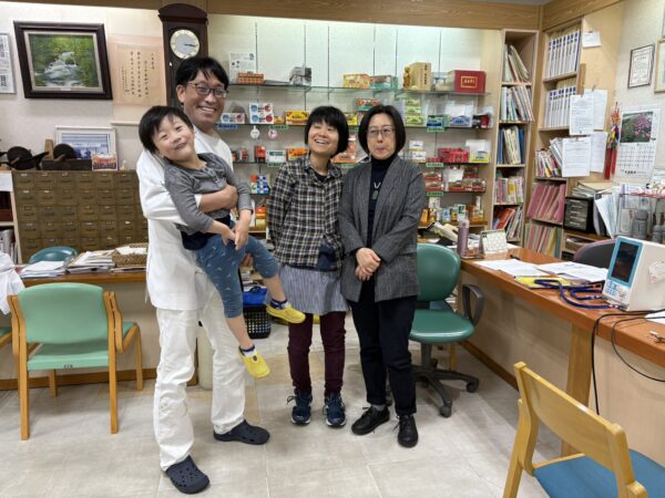 ４歳の息子を抱っこして妻と楊 紅娜先生と写真に収まる土屋幸太郎です。